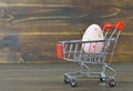 Easter shopping cart with Easter egg Royalty Free Stock Photo