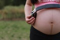 Close-up of Eastern Asian Chinese pregnant woman's belly, earphones on belly, antenatal training fetal education baby family