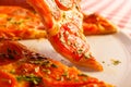 Close up eating piece of pizza Margarita. Delicious hot food sliced and served on white platter. Menu photo, Italian Royalty Free Stock Photo