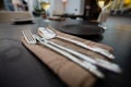 Close up of eating utensils and napkin on table Royalty Free Stock Photo