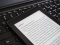 Close up of ebook reader with The Holy Bible on a laptop keyboard, with sun rays light concept Royalty Free Stock Photo