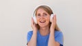 Close-up of ecstatic young woman listening to music in headphones