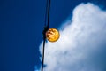 Close up of an Edison-style filament on a light bulb against a cloudy sky. Energy crisis Royalty Free Stock Photo