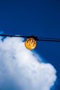 Close up of an Edison-style filament on a light bulb against a cloudy sky. Energy crisis Royalty Free Stock Photo