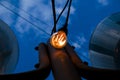 Close up of an Edison-style filament on a light bulb against a cloudy sky. Energy crisis Royalty Free Stock Photo