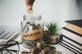close-up education object with stack money coin-cash dollar and glass jar on background. Concept to saving money income for study Royalty Free Stock Photo