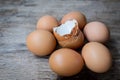 Close-up of egg shell and fresh eggs on wooden background Royalty Free Stock Photo