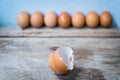 Close-up of egg shell and fresh eggs on wooden background Royalty Free Stock Photo