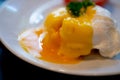 Close up of eggs benedict with liquid egg yolk running out Royalty Free Stock Photo