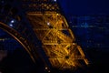 Close-up of Eiffel Tower arch at blue evening dusk