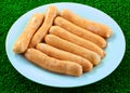 Closeup of uncooked chipolata sausages.