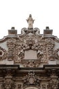 Close up of elaborate carvings and sculptures at the top of the Casa del Prado building in Balboa Park, San Diego, California