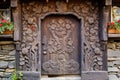 close-up of elaborately carved door of a mountain cottage