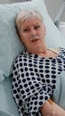 Close up of elder patient laying in bed and talking to medic Royalty Free Stock Photo