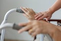 Elderly asian woman using a walker at home with caregiver take c Royalty Free Stock Photo