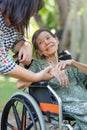 Elderly asian woman on wheelchair at home with daughter take care Royalty Free Stock Photo