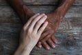 Close-up of elderly caregiver and daughter's hands