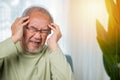 Close up of elderly holds head with hand suffering from migraine headache Royalty Free Stock Photo