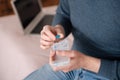 Close-up of elderly man holding pill