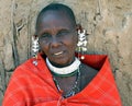 Close up elderly Masai woman with red blanket, hand-made jewellery