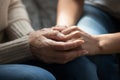 Close up of elderly mom and adult daughter hold hands Royalty Free Stock Photo