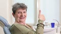 Close up of elderly woman giving thumbs up at dental ordination