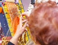 Close-up of an elderly woman head working on bobbin lace Royalty Free Stock Photo