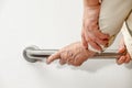 Elderly woman holding on handrail with caregiver Royalty Free Stock Photo