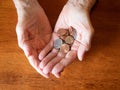 Close Up of Elderly Woman`s Hands Holding Coins