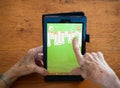 Close Up of an Elderly Woman`s Hands Playing Solitaire on a Tabl Royalty Free Stock Photo