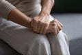 Close up of pensive mature hands joined on laps Royalty Free Stock Photo