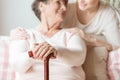 Close-up of elderly woman holding walking stick in the nursing h