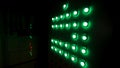 Close up for the electric control panel with push buttons and light display in the dark room. Stock footage. Green