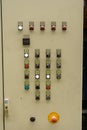 Close up of electric control panel with switches, multi colored indicators and emergency stop Royalty Free Stock Photo