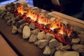 Close up of electric fireplace with orange and yellow fire flame. Royalty Free Stock Photo