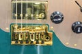 electric guitar bridge with volume and tone knobs and gold pickup Royalty Free Stock Photo