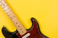 Close-up of electric guitar on yellow background, with copy space Royalty Free Stock Photo