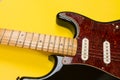 Close-up of electric guitar on yellow background, with copy space Royalty Free Stock Photo