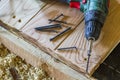 Close up of electric screwdriver with some screws laying on old Royalty Free Stock Photo