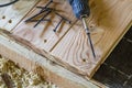 Close up of electric screwdriver with some screws laying on old Royalty Free Stock Photo