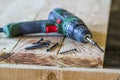 Close up of electric screwdriver with some screws laying on old Royalty Free Stock Photo