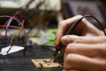 Close Up Of Electrical Engineer Soldering Circuit Board