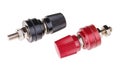 Red and black binding post connector with screw threaded terminal isolated on a white background