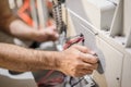 Close up of electrician engineer works with electric cable wires Royalty Free Stock Photo