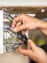 Close up of electrician engineer works with electric cable wires Royalty Free Stock Photo