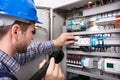 Electrician Examining A Fuse Box