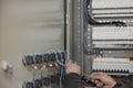 Close-up of electrician hands working on switches in control room Royalty Free Stock Photo