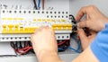 Close-up of electrician\'s hands working on electrical wiring and circuit breakers in a panel Royalty Free Stock Photo