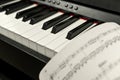 close-up of electronic piano keys. paper sheet with musical notes. Royalty Free Stock Photo