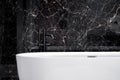 Close-up on elegant bathtub with black tap Royalty Free Stock Photo